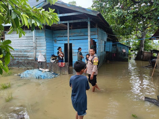 
 Aipda Hamdan Sigap Pantau Kondisi Banjir di Waetuwo, Warga Diminta Tetap Waspada