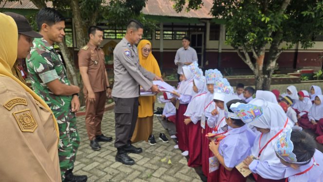 
 Bhabinkamtibmas Hadiri Penyerahan Seragam Sekolah Gratis di SD Inpres 7/83 Pasempe